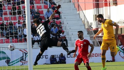 Giannou Apostolos, right, of Australia scores. EPA