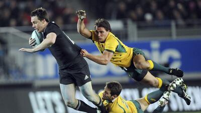 New Zealand’s Ben Smith is tackled by Australia’s Bernard Foley, and Nick Phipps, up, during the International test Bledisloe Cup rugby match at Eden Park in Auckland, New Zealand, Saturday, Aug. 23 2014. (AP Photo/SNPA, Ross Setford) NEW ZEALAND OUT
