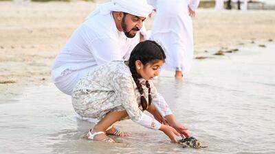 Sheikh Hamdan bin Zayed, chairman of the board at Environment Agency Abu Dhabi, and his family during the release of turtles at Saadiyat Beach last year. Photo: Abu Dhabi Media Office