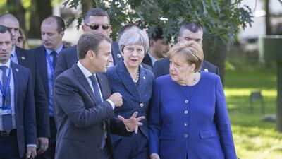 Emmanuel Macron, Theresa May, and Angela Merkel walk in the gardens of the National Palace of Culture ahead of a summit of European Union leaders in Sofia, Bulgaria, May 17, 2018. Bloomberg
