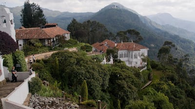 On the hillside above Bogota Colombia is Monserrate, the city's symbol, where two restaurants offer great views and food. Alamy