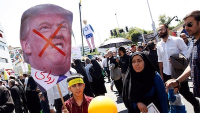 An Iranian boy holds a poster of US President Donald Trump during an anti-Israel rally marking Al Quds Day. Abedin Taherkenareh / EPA