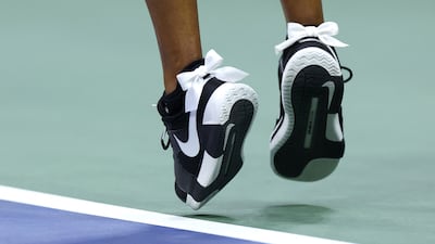 Naomi Osaka wearing white bows on her Nike trainers during her match against Karolina Muchova at the 2024 US Open. AFP
