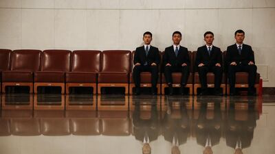 Chinese security officers pictured sitting outside the National People’s Congress in Beijing, China. Roman Pilipey / EPA
