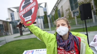 An environmental activist holds a sign that reads 'Stop Coal!' Getty.