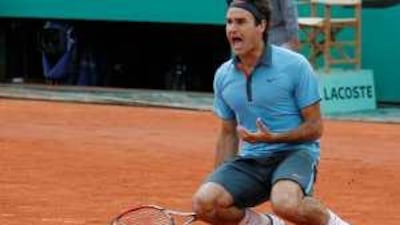 Roger Federer falls to his knees after beating Robin Soderling to win his first French Open title at Roland Garros in Paris.