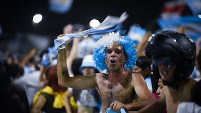 Fans gather outside the Argentinian Football Association headquarters ahead of the team bus arrival. Reuters