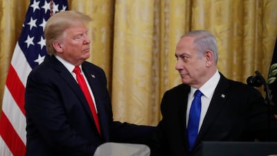 Israeli Prime Minister Benjamin Netanyahu and President Donald Trump shake hands, obscured by the top of a teleprompter, in the East Room of the White House in Washington, Tuesday, Jan. 28, 2020, to announce the Trump administration's much-anticipated plan to resolve the Israeli-Palestinian conflict. (AP Photo/Alex Brandon)