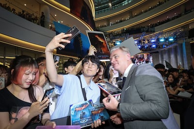 Director Christopher Nolan, right, has been credited with a resurgence in premium cinema experiences worldwide. Getty Images