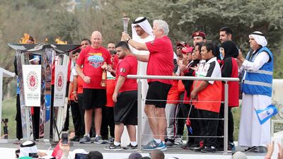 Dr Sultan Al Jaber takes the flame at the Founder’s Memorial in Abu Dhabi. This flame will now go to Fujairah. Pawan Singh / The National