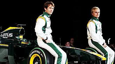 Drivers Jarno Trulli of Italy and Heikki Kovalainen of Finland pose with the Lotus T127 during the launch in London last month.