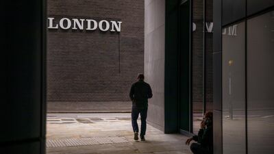 A pedestrian walks past a sign in the City of London. The Bank of England expects the unemployment rate to hit 7.5 per cent by the end of the year. Bloomberg