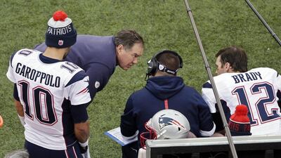 New England Patriots head coach Bill Belichick, second from left, talks to Tom Brady during their game against the New York Jets in the NFL on Sunday. Peter Morgan / AP / December 27, 2015