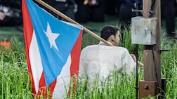 Bad Bunny holds a Puerto Rican flag during his Super Bowl half-time performance. EPA