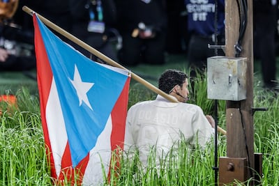 Bad Bunny holds Puerto Rican flag while performing at the Super Bowl half-time show. EPA