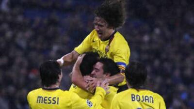 Barcelona players celebrate after Sergi Busquets scores the second goal in a 5-0 rout of Swiss side Basel.
