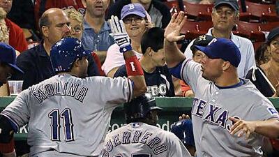 Bengie Molina, left, is congratulated by pitcher Colby Lewis after completing his cycle.