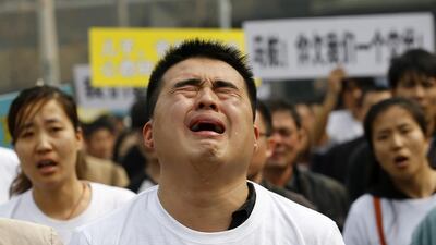 A family member of a passenger on board Malaysia Airlines MH370 cries as he shouts slogans during a protest in front of the Malaysian embassy in Beijing, March 25, 2014. Angry relatives of Chinese passengers aboard the missing Malaysia Airlines plane denounced the Kuala Lumpur government and its national carrier as “executioners” on Tuesday and said they would march on the Malaysian Embassy. Kim Kyung-Hoon / Reuters