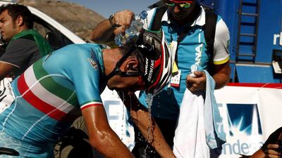 Astana Pro Team rider Vincenzo Nibali of Italy is cooled with water by a team member after finishing the second stage of the Vuelta a Espana on Sunday. Jon Nazca / Reuters / August 23, 2015