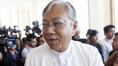In this Monday, Feb. 1, 2016 photo, Htin Kyaw, center, walks in Naypyitaw, Myanmar. The National League for Democracy party, which won November 2015 general elections by a landslide, nominated two Suu Kyi loyalists to contest the president's post Thursday. They are 70-year-old Oxford graduate Htin Kyaw and Henry Van Hti Yu, an ethnic Chin minority and upper house NLD lawmaker. (AP Photo/Aung Shine Oo)