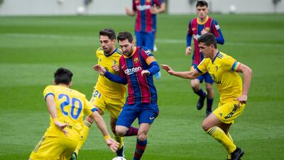 Barcelona's Lionel Messi attempts to find a way through a crowd of Cadiz players. AP