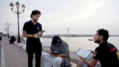 Members of the Abu Dhabi Awards team collect nominations from residents at Abu Dhabi’s Breakwater last May. Christopher Pike / The National