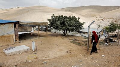 A Palestinian woman walks in the Palestinian Bedouin village of Khan Al Ahmar, east of Jerusalem, in the occupied West Bank, on October 21, 2018. AFP