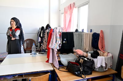 A displaced woman in a school classroom doubling as a shelter in the southern port city of Tyre, Lebanon. EPA
