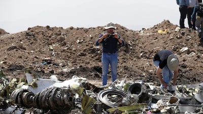 American civil aviation and Boeing investigators search through the debris. Reuters