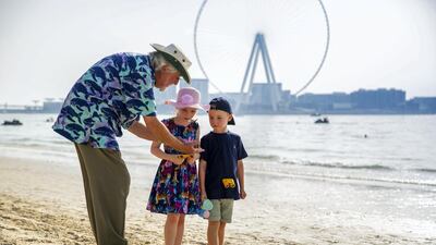 Jean-Michel Cousteau teaches children about the world's waters and the species that live within on a Dubai beach. Courtesy The Ritz-Carlton