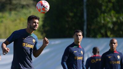 Portugal attacker Goncalo Ramos heads the ball as Cristiano Ronaldo and Joao Mario look on. EPA