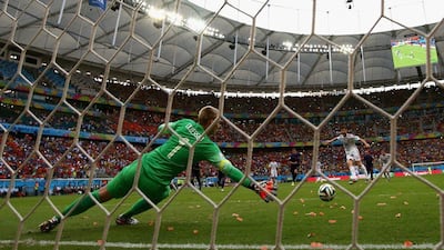 Xabi Alonso of Spain converts a penalty past Netherlands keeper Jasper Cillessen to put his side 1-0 up in the first half of Friday's World Cup Group B opening match between the teams at the Arena Fonte Nova in Salvador, Brazil. David Ramos / Getty Images