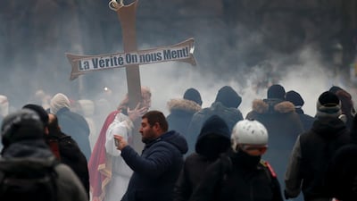 A protester carries a cross bearing the legend: 'Truth. We are being lied to'. Reuters