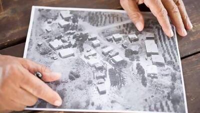 Shahdi Abu Al Qian shows an aerial view of the homes he had shared with his three wives and 32 children in Atir.