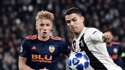 Juventus forward Cristiano Ronaldo, right, prepares to shoot past Valencia's Daniel Wass. AFP