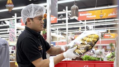 A store staff at Aswaaq's outlet at Mizhar in Dubai. Razan Alzayani / The National