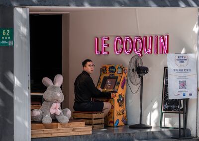 A man plays games on the entrance of the restaurant in Shanghai, China, 22 September 2021. Douyin, China's version of the famous short video app TikTok, will limit the use of the platform for children under 14 years old to 40 minutes a day. The new rules come as China limits teenagers' use of technology. EPA