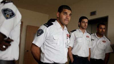 From left, Wahaid Salah Mohammed, Omar Alotaibi and Mohammed Abdulla await their diplomas as first aid instructors.