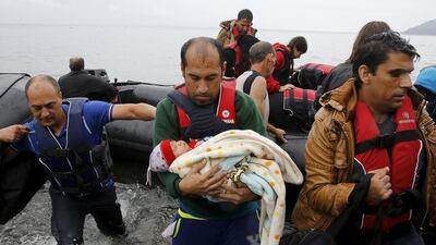 A Syrian refugee carries his baby off an overcrowded dinghy after crossing part of the Aegean Sea from Turkey to the Greek island of Lesbos. Yannis Behrakis / Reuters