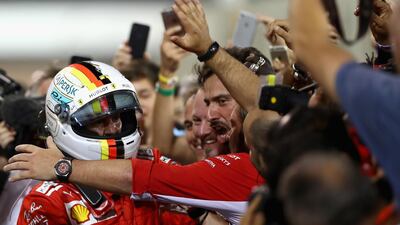 Ferrari's German driver Sebastian Vettel celebrates in parc ferme following the Bahrain Grand Prix. Clive Mason / Getty Images