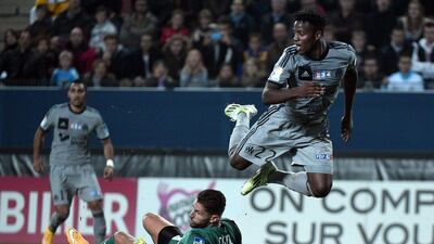 Marseille's Michy Batshuayi jumps over Rennes keeper Benoit Costil during his side's Coupe de la Ligue loss on Wednesday night. Damien Meyer / AFP / October 29, 2014
