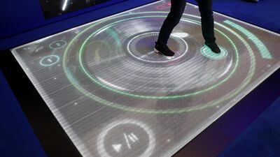 An attendee dances on an electronic dance floor as they play a fitness challenge game at the Samsung pavilion on day two of the MWC. Bloomberg