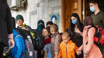 Holding hands, the orphaned children of suspected ISIS fighters are given into the care of a Russian delegation by Syrian Kurdish officials in Qamishli, north-east Syria. AFP