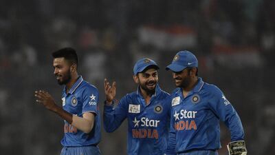 Indian cricketers Hardik Pandya (L) and Virat Kohli (C) and captain Mahendra Singh Dhoni react after the dismissal of the Pakistan cricketer Mohammad Sami during the match between India and Pakistan at the Asia Cup T20 cricket tournament at the Sher-e-Bangla National Cricket Stadium in Dhaka on February 27, 2016. AFP PHOTO/Munir uz ZAMAN