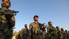 Members of an SDF brigade at a funeral for three Kurdish fighters killed in Aleppo, Syria. AFP