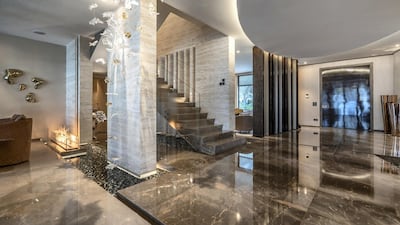 Entry is through a wooden door with metal accents. custom-built wood door with metal accents