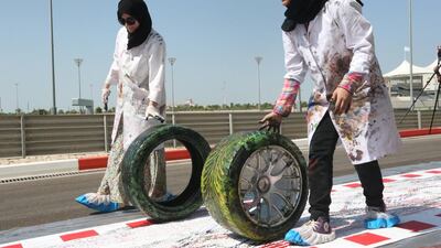Fifty Zayed University students rolled tyres covered in paint along a 200-metre canvas in what could be deemed the world’s longest fine-art print. Fatima Al Marzooqi / The National