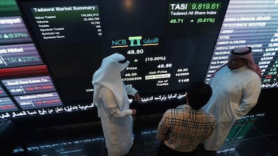 Investors monitor screens displaying stock information at the Saudi Stock Exchange (Tadawul) in Riyadh November 12, 2014. Shares in Saudi Arabia’s biggest lender, National Commercial Bank, jumped their daily 10 percent limit upon listing on Wednesday after a $6 billion IPO, the largest ever in the Arab world and the second-biggest globally this year. /Faisal Al Nasser / Reuters