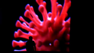 A man passes by an LED outdoor screen during the coronavirus outbreak in Brasilia, Brazil. Reuters