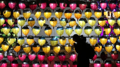 A woman prays in front of a wall of lanterns to celebrate the New Year at the Jogyesa Buddhist temple in Seoul, South Korea. AP Photo